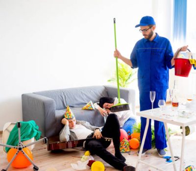 A janitor is cleaning a mess after a party